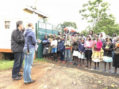We cut the welcome ribbon while the children and shared flowers with us. 